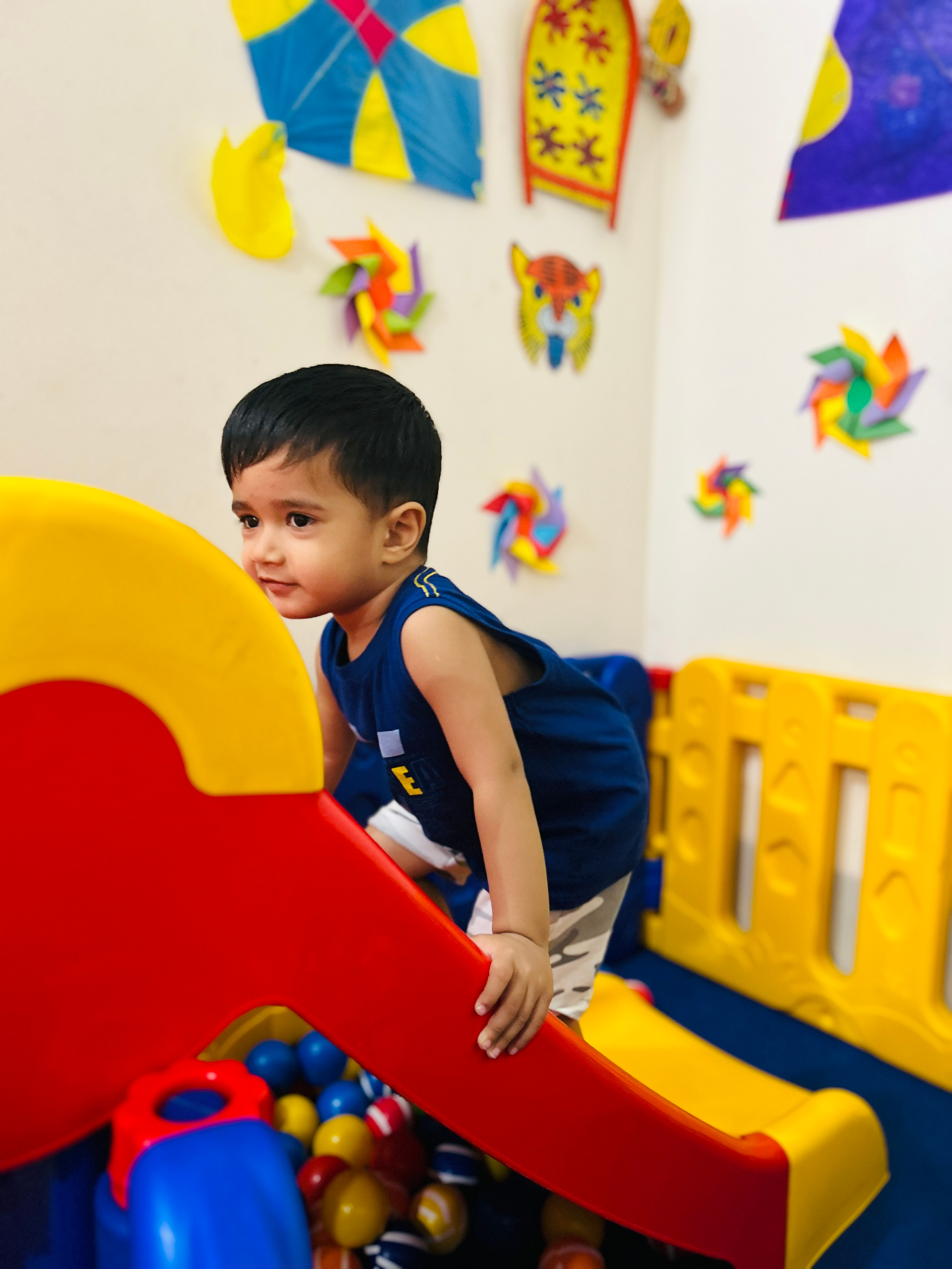 Toddler playing in a colorful, secure setting.